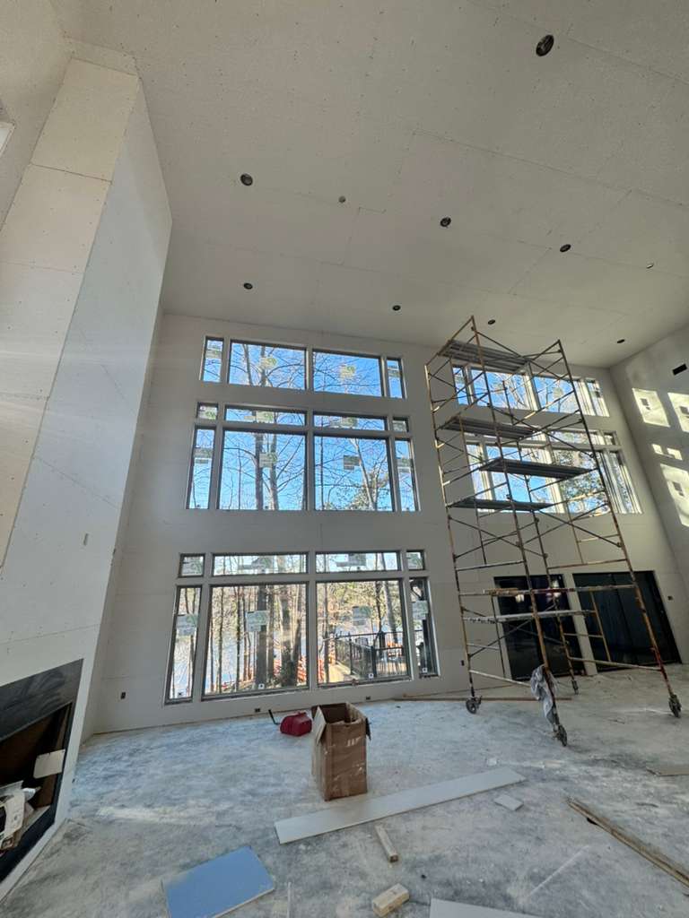 Installers applying window film to a multi-story commercial building